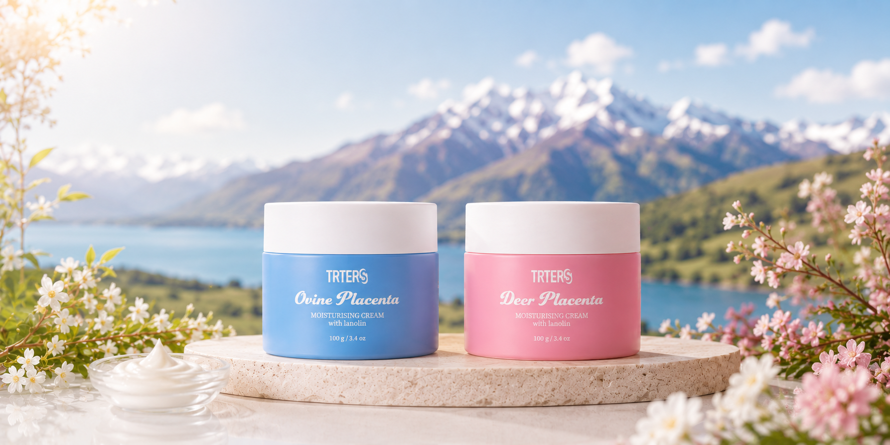 TRTERS Ovine and Deer Placenta creams on a stone podium beside a New Zealand lake, mountains and spring blossom